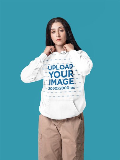 Comfort Colors Hoodie Mockup Featuring a Woman Posing in a Studio Setting With Serious Expression m57407