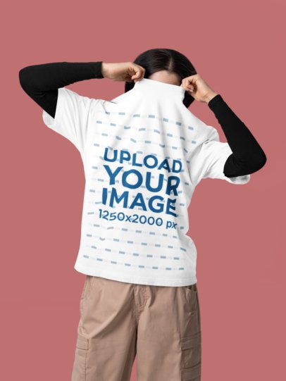 Oversized T-Shirt Mockup of a Woman Hiding Her Face in a Studio Set m57408