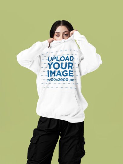 Comfort Colors Mockup of a Woman Hiding Half Her Face With a Hoodie in a Studio m57415