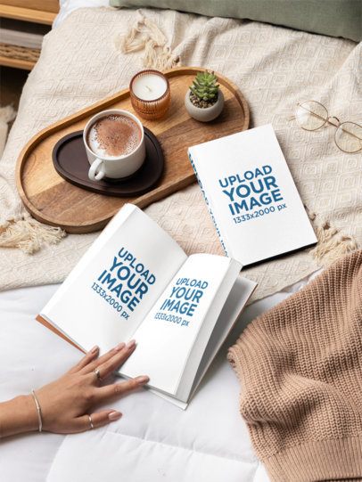 Book Mockup Featuring a Woman Reading in a Cozy Bed With a Cup of Hot Chocolate