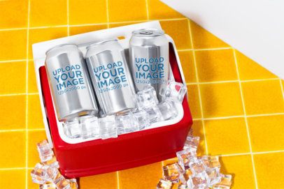 Mockup Featuring Three Cans Placed Inside a Cooler Filled With Ice
