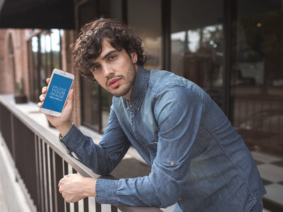 Mockup of a Man with Curly Hair Holding a Gold iPhone 8 Plus