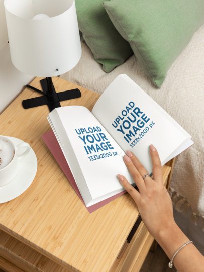 Mockup of a Woman Opening Pages of a Book on a Nightstand