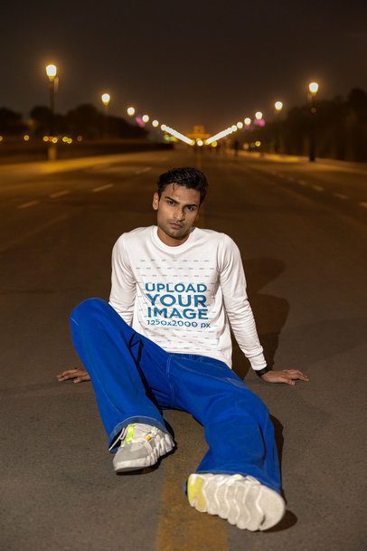 Sweatshirt Mockup Featuring a Man Sitting on the Street Pavement