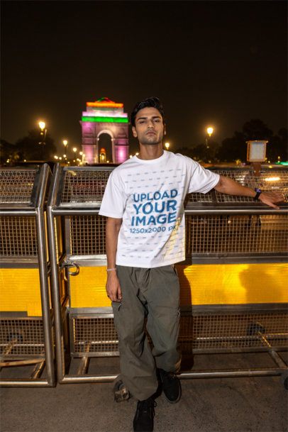 Oversized Tee Mockup Featuring a Man Posing on a Bridge Against a City