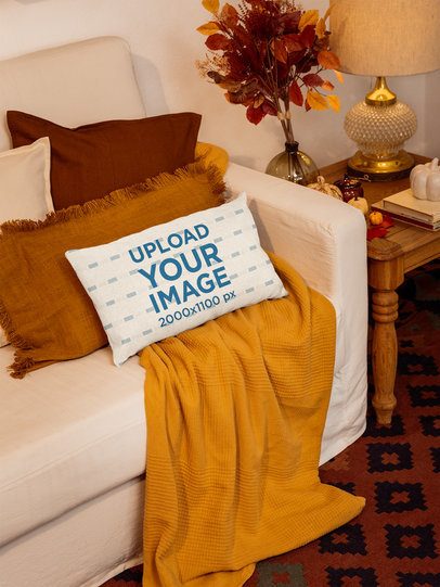 Mockup Featuring a Pillow Lying on a Sofa With Fall Decorations