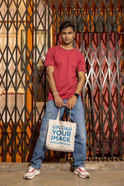Mockup of a Man Carrying a Sublimated Tote Bag in a Street at Night m56888