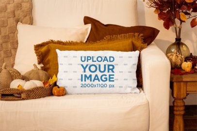 Mockup of a Pillow Placed on a Couch in a Fall-Themed Setting