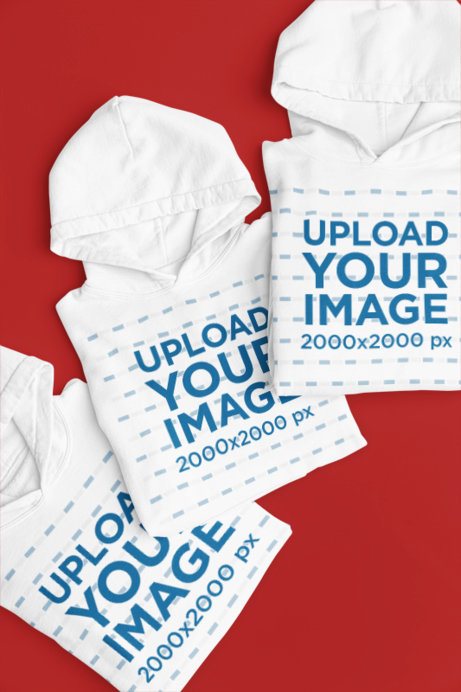 Mockup of Three Gildan Pullover Hoodies Placed on a Colorful Backdrop
