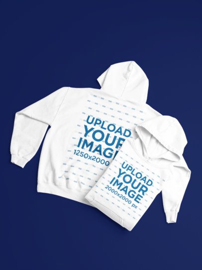 Gildan Mockup Featuring Two Pullover Hoodies Lying on a Customizable Setting m52200