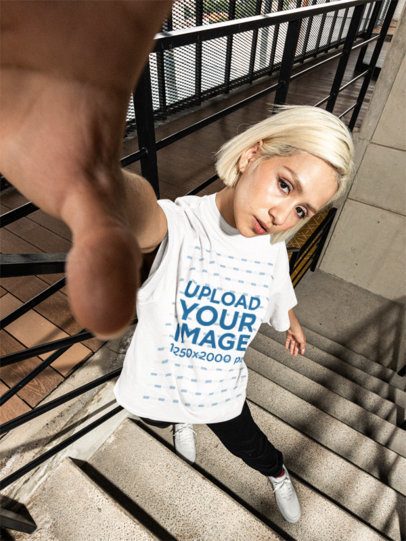 Oversized T-Shirt Mockup of a Woman Taking a Selfie on a Staircase Building m57625