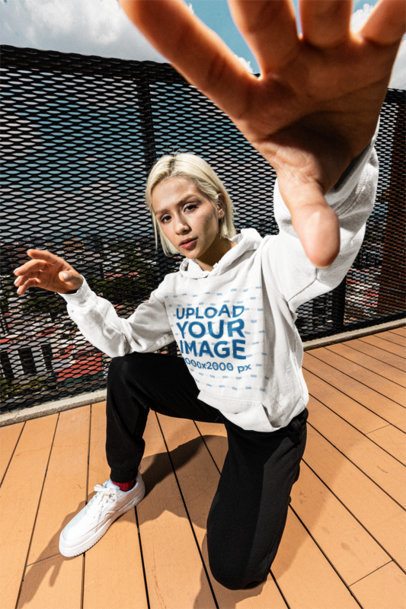 Comfort Colors 1567 Hoodie Mockup Featuring a Woman Posing on a Wooden Floor on a Rooftop m57618