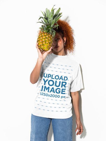 Oversized T-Shirt Mockup Featuring a Woman Hiding Her Face Behind a Pineapple m58986
