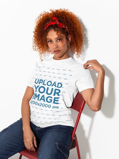 Comfort Colors 1717 Tee Mockup Featuring a Woman Sitting on a Chair in a Studio m58994