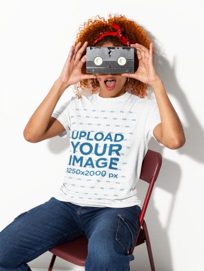 Comfort Colors 1717 T-Shirt Mockup of a Woman With a Surprised Look Hiding Her Face With a VHS m58995