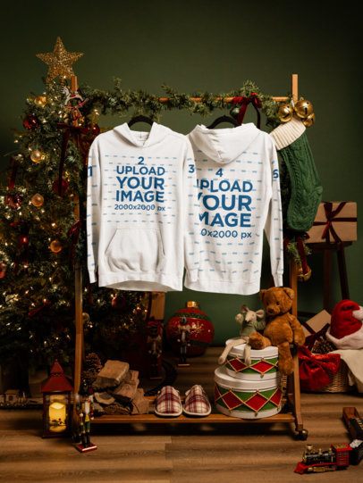 Mockup of Two Comfort Colors 1567 Garment-Dyed Hoodies Hanging in a Cozy Christmas Room m59338