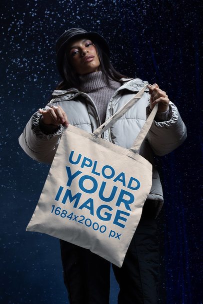 Mockup of a Woman Showing a Tote Bag in a Winter-Themed Setting m59232