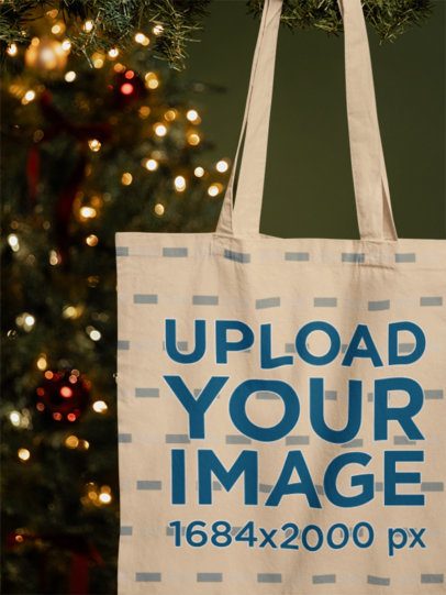 Mockup of a Tote Bag Hanging From a Christmas Tree m59333