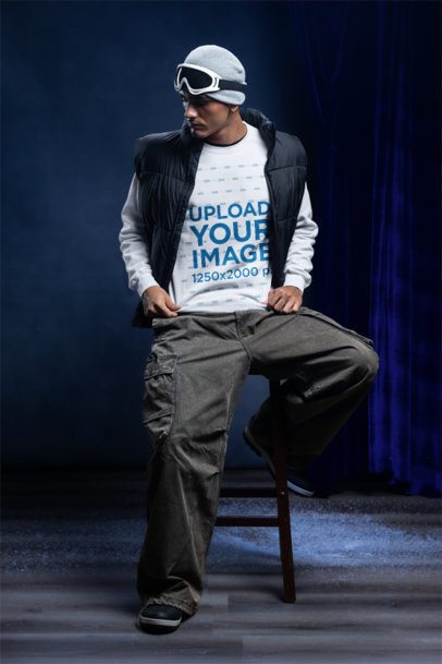 Comfort Colors 1566 Sweatshirt Mockup Featuring a Man Sitting on a Stool in a Winter Setting
