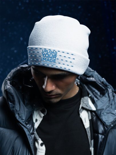 Mockup of a Man Wearing a Yupoong 1501KC Beanie in a Cold-Themed Setting