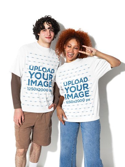 Oversized T-Shirt Mockup of a Happy Man With a Woman Making a Rock and Roll Sign m58989