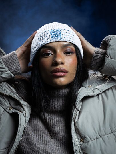 Mockup of a Stylish Woman Wearing a Beanie in a Winter-Themed Studio Set