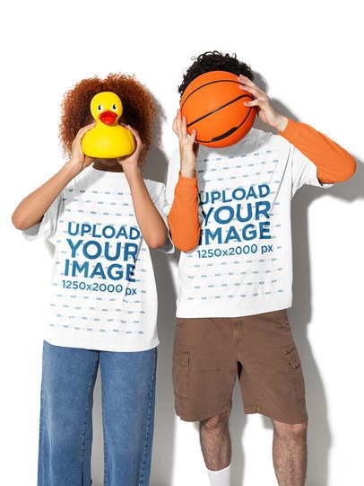 Oversized Tee Mockup Featuring a Man and a Woman Hiding Their Faces With a Rubber Duck and a Ball m58990