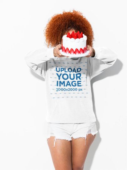 Comfort Colors 1567 Garment-Dyed Hoodie Mockup of a Woman Holding a Cake in Front of Her Face m59004