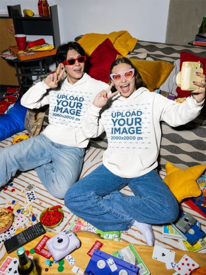 Comfort Colors 1567 Hoodie Mockup of a Happy Man and a Woman Taking a Selfie in a Living Room m58528