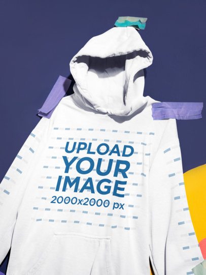 Close-Up of a Comfort Colors 1567 Garment-Dyed Hoodie Mockup Taped to a Colorful Mural m59087