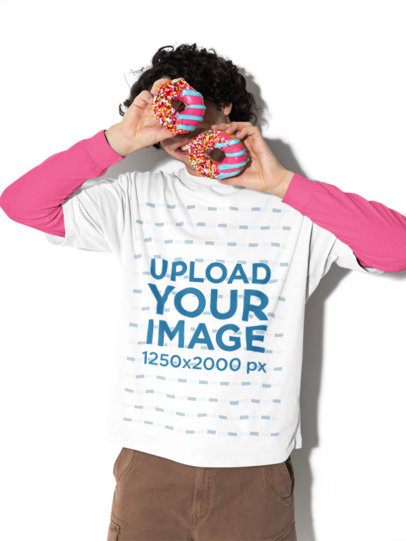 Oversized T-Shirt Mockup of a Smiling Man Hiding His Face With Two Donuts m58991