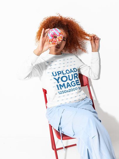Comfort Colors 6014 Mockup Featuring a Woman in a Long-Sleeve Tee Posing With a Donut m59014
