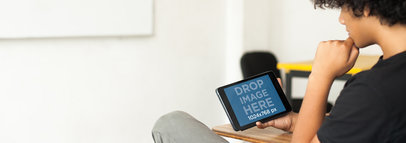 Tablet Mockup of a Boy Using a Black iPad Mini at School