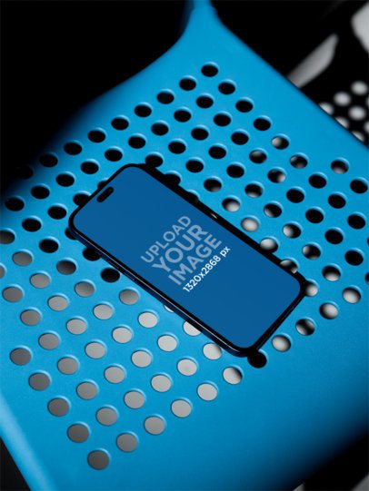 Mockup of an iPhone 17 Pro Max Lying on a Plastic Chair