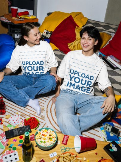 Oversized T-Shirt Mockup Featuring a Young Man and a Woman Sitting on the Floor With Snacks m58525