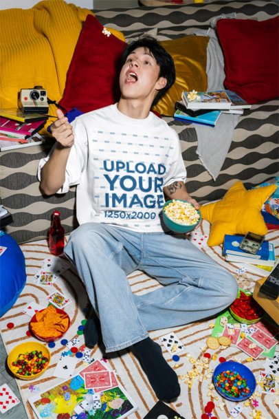Oversized T-Shirt Mockup of a Man Catching a Popcorn With His Mouth m58523