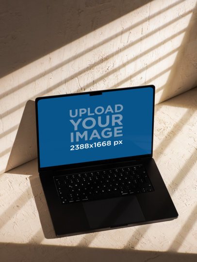 Minimalistic-Inspired Mockup Featuring a MacBook Placed Against a Wall