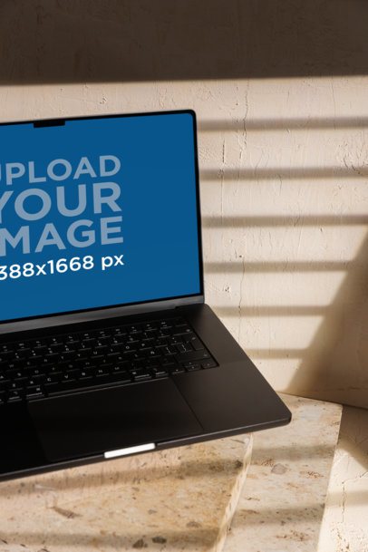 Mockup of an Open MacBook Placed on a Minimalist Set