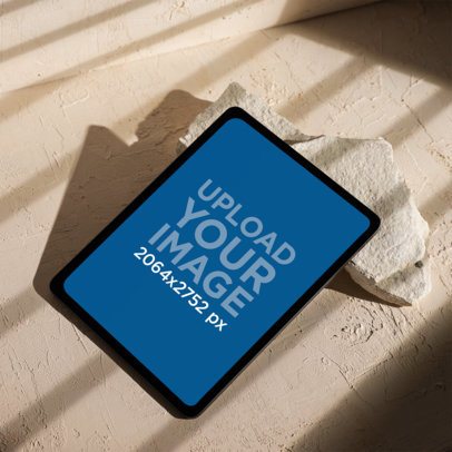Mockup of an iPad on an Aesthetic Beige Surface with Natural Light