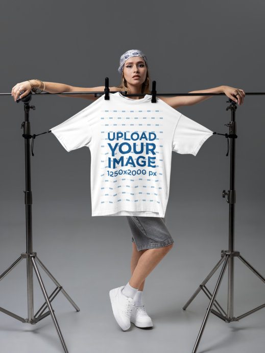 Placeit - Mockup of a Serious Woman Posing With an Oversized T-Shirt in ...