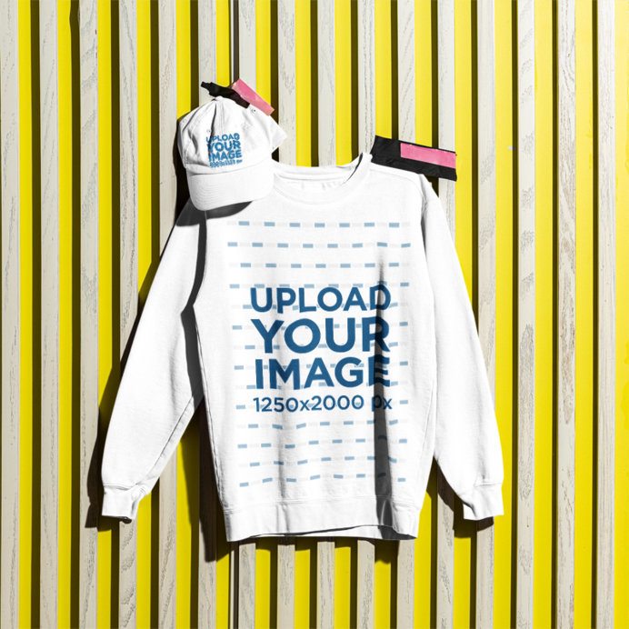 Mockup of a Dad Hat and a Comfort Colors 1566 Sweatshirt Pinned on a Wall