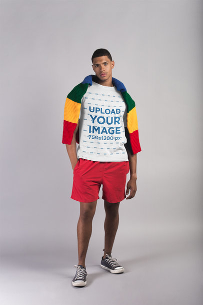 T-Shirt Mockup of a Man with Beach Clothing in a White Room