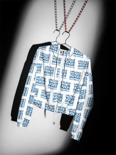 Windbreaker Jacket Mockup featuring a Front View Hanging on a Wire Hanger in a Dramatic Studio Setting m59806