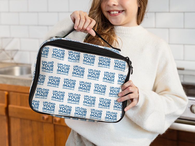 Lunch Bag Mockup with a Young Kid in a White Sweater Posing in front of a Tiled Wall