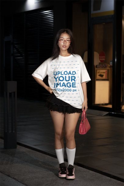 T-Shirt Mockup with an Alternative Female Model wearing a Black Ruffled Mini Skirt Urban at Night m54195