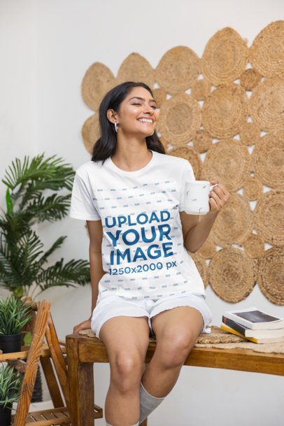Tee Mockup of a Female Model enjoying a Hot Drink in a Boho Style Room m55413