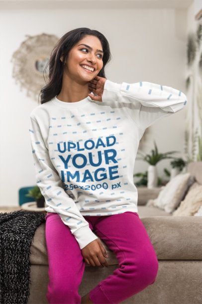 Sweatshirt Mockup featuring a Smiling Gen Z Woman looking away on a Living Room Couch m55389