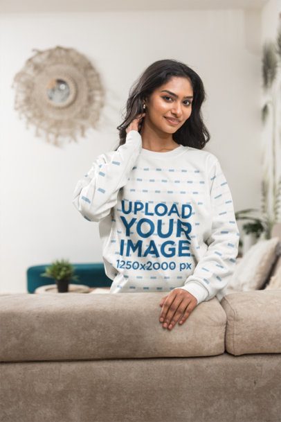Sweatshirt Mockup featuring a Smiling Gen Z Woman leaning on a Living Room Couch m55393