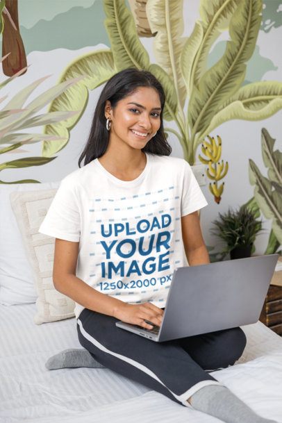 Tee Mockup of a Female Model working on her Computer in Bed m55427