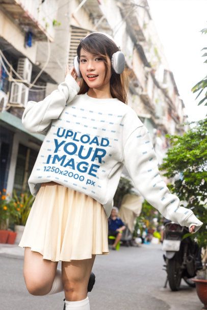 Crew Neck Sweatshirt Mockup of an East Asian Female Model Posing Playfully with a K-Drama Aesthetic in a City Alleyway m55324